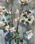 Close up of a framed vintage oil painting of white apple blossom flowers.