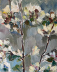 Close up of a framed vintage oil painting of white apple blossom flowers.