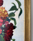 Framed, vintage, still life oil painting of a bouquet of red flowers.