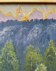 Framed, vintage, oil painting of a landscape with trees and mountains.