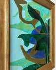 Close up of a framed, green & blue mixed media artwork with abstract design.