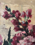 Close up of a vintage oil painting on canvas of a bouquet of dark pink hydrangeas in a glass vase.