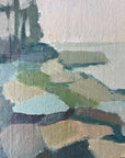 Close up of a framed semi-abstract landscape mid-century oil painting of a coastline.