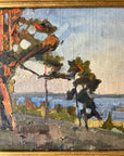 Close up of a framed, vintage oil painting of a landscape with trees and a body of water.