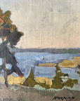Close up of a framed, vintage oil painting of a landscape with trees and a body of water.
