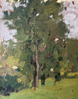 Close up of a framed vintage oil painting of a landscape with trees and a meadow.