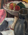 Close up of a framed still life oil vintage painting with watermelon, fruit, and jug on a table.