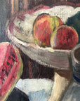 Close up of a framed still life oil vintage painting with watermelon, fruit, and jug on a table.