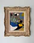 A framed abstract floral painting with bold geometric shapes in blue, black, yellow, green, and beige, housed in an ornate gold-toned frame. Available at Hue.