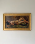 A framed vintage oil painting of a reclining nude figure, housed in a gold frame. Available at Hue.