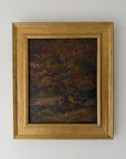 A framed vintage oil painting depicting a dark, moody forest scene with trees and cows. Available at Hue.