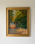 A framed vintage impressionist landscape oil painting depicting a sunlit garden path through dense green and yellow foliage leading to a red gate. Available at Hue.