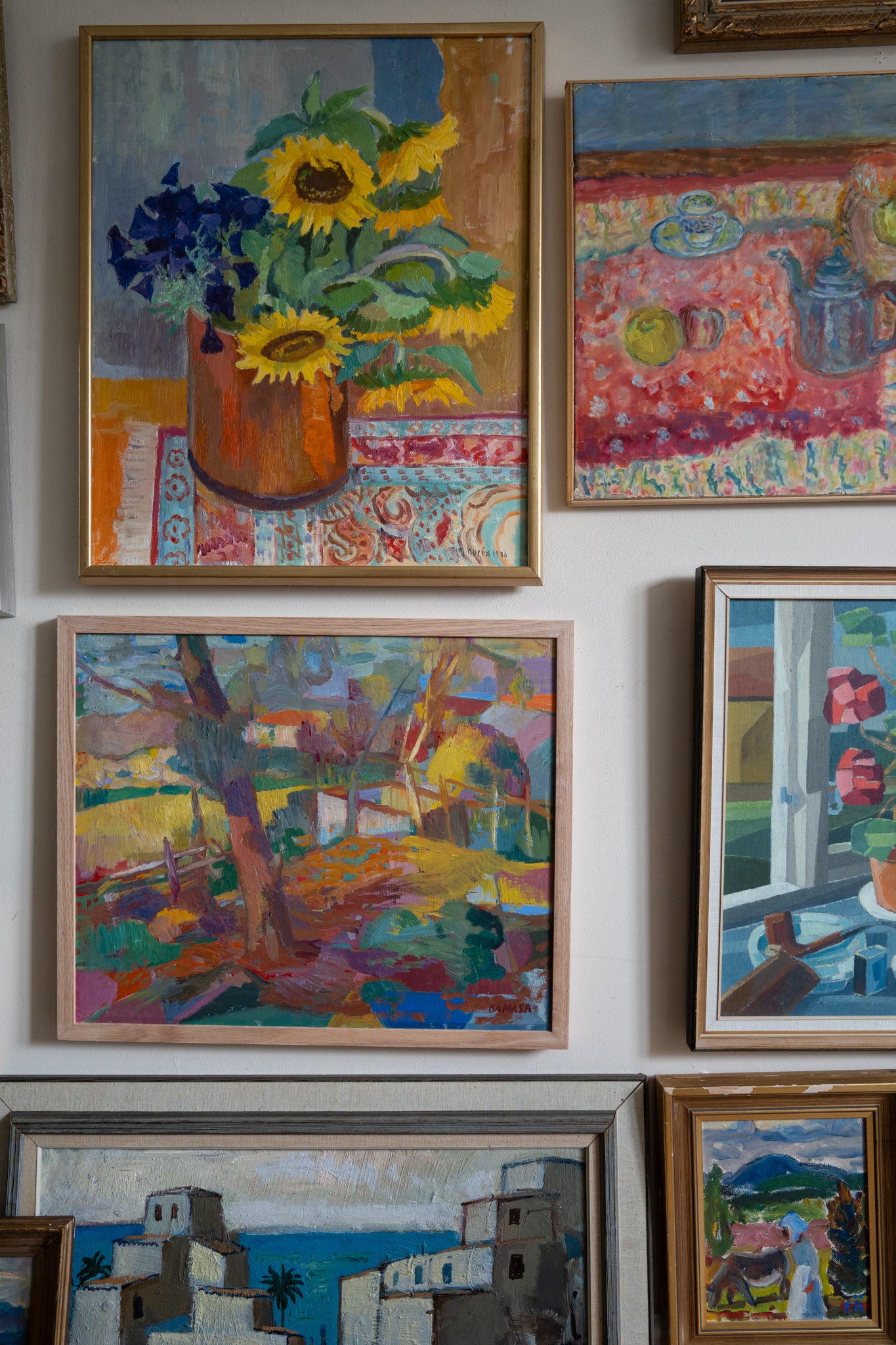 Collection of colorful paintings on a wall from hue