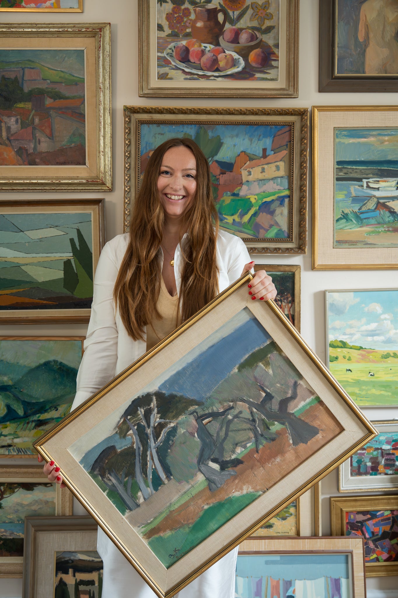 gallery wall curation of various framed vintage landscapes and stlil life