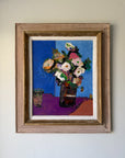 A framed still life painting of a flower bouquet in a dark vase against a blue background. Available at Hue.