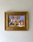 A framed vintage landscape oil painting of palm trees and a small coastal village. Available at Hue.