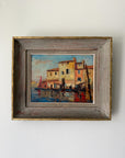 Framed vintage oil painting of a harbour scene with a sail boat. Available at Hue.