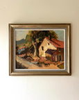 Framed vintage oil painting of a whote cottage and trees. Available at Hue.