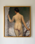 Framed vintage oil painting of a nude woman standing by a bed curtain. Available at Hue.