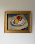 A framed vintage still life oil painting of two apples on a plate. Available at Hue.