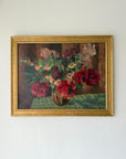 Framed vintage oil painting of a still life with flowers on a table. Available at Hue.