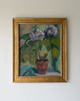 Framed vintage oil painting of pale blue florals in a terracotta pot. Available at Hue.