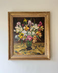 A framed vintage oil painting of a vase of flowers on a dark background. Available at Hue.