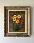 Framed vintage oil painting of a vase with colorful zinnia flowers in an ornate vintage frame, available at Hue.