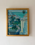 Framed vintage oil painting of a coastal scene with buildings and trees. Available at Hue.