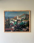 Framed vintage oil painting of a coastal village scene, available at Hue.