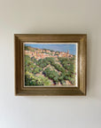 Framed vintage oil painting of a hillside village in Corsica, available at Hue.