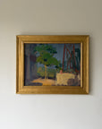A framed vintage oil painting depicting a garden scene with green trees and a table. Available at Hue.