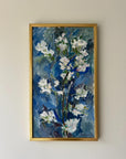 Framed vintage oil painting of white apple blossom flowers on a blue background framed in a vintage gilt frame, available at Hue.