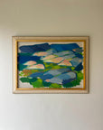 A framed vintage oil painting of a blue semi-abstract landscape. Available at Hue.
