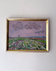 Framed vintage oil painting of a landscape with fields and clouds. Available at Hue.