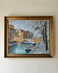 Framed vintage oil painting of a canal scene with trees and buildings in a vintage gilt frame, available at Hue.