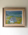 Framed vintage oil painting of a coastal scene with a cottage. Available at Hue.