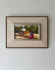 Framed vintage painting of a landscape with a house and people, available at Hue.