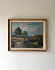 A framed vintage oil painting of a Nordic landscape with a pathway and trees. Available at Hue.