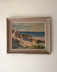 Framed vintage oil painting of a coastal landscape. Available at Hue.