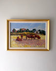 Framed vintage oil painting of cows in a field. Available at Hue.