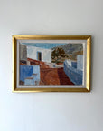 Framed vintage oil painting of a Mediterranean scene with white buildings and blue sky. Available at Hue.