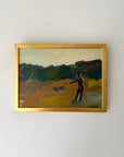Framed vinatge oil painting of a person with a dog on a landscape. Available at Hue.