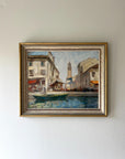 A framed vintage oil painting of a Venetian canal scene. Available at Hue.