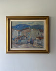 Framed vintage oil painting of a village scene with mountains. Available at Hue.
