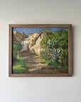 Framed vintage oil painting of a village scene with greenery in a solid walnut frame, available at Hue