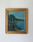 A framed vintage landscape oil painting featuring blue water, green hills, and dark trees. Available at Hue.
