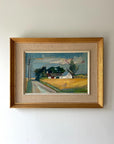Framed vintage oil painting of a rural landscape with a house and yellow fields in a gilt frame with linen mount, available at Hue.