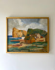 Framed vintage oil painting of a coastal scene with houses and boats in a gilt frame, available at Hue.
