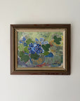 Framed vintage oil painting of flowers in a pot. Available at Hue.